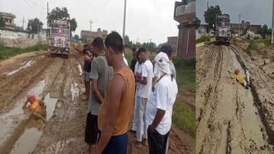 भाजपा नेता अरुण कुमार सिंह देवरिया की टूटी सड़क पर कीचड़ में लेटकर अनोखा प्रदर्शन करते हुए