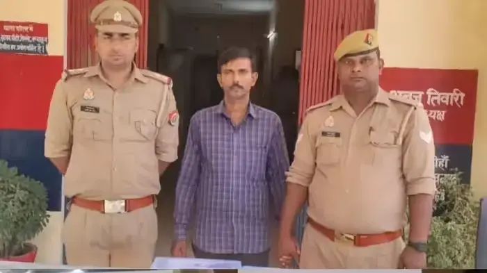 दो पुलिसकर्मी एक संदिग्ध व्यक्ति के साथ थाने में खड़े हैं