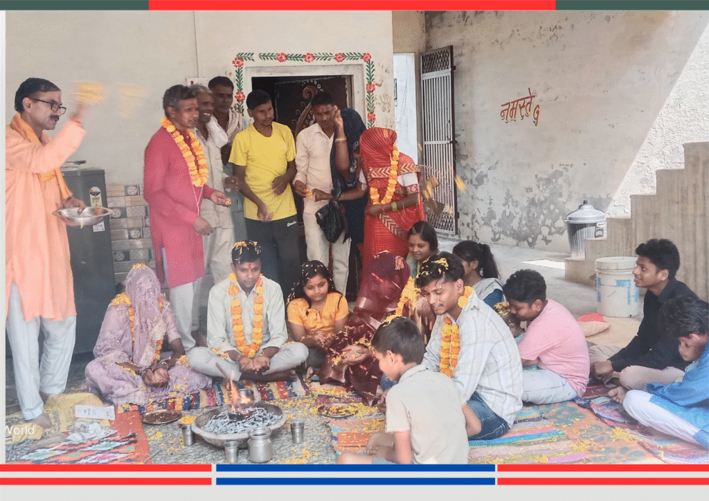 सामूहिक रूप से हवन संस्कार करते हुए, चारों ओर गेंदा फूल की माला और पूजा सामग्री रखी है, पंडित आहुति दे रहे हैं।