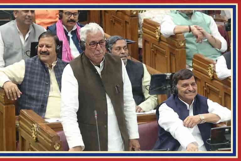 उत्तर प्रदेश विधानसभा सत्र के दौरान सदन में खड़े होकर बोलते वरिष्ठ नेता, आसपास बैठे अन्य सदस्य मुस्कुराते हुए